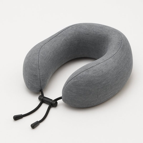 Gray neck pillow with a black strap on a white background