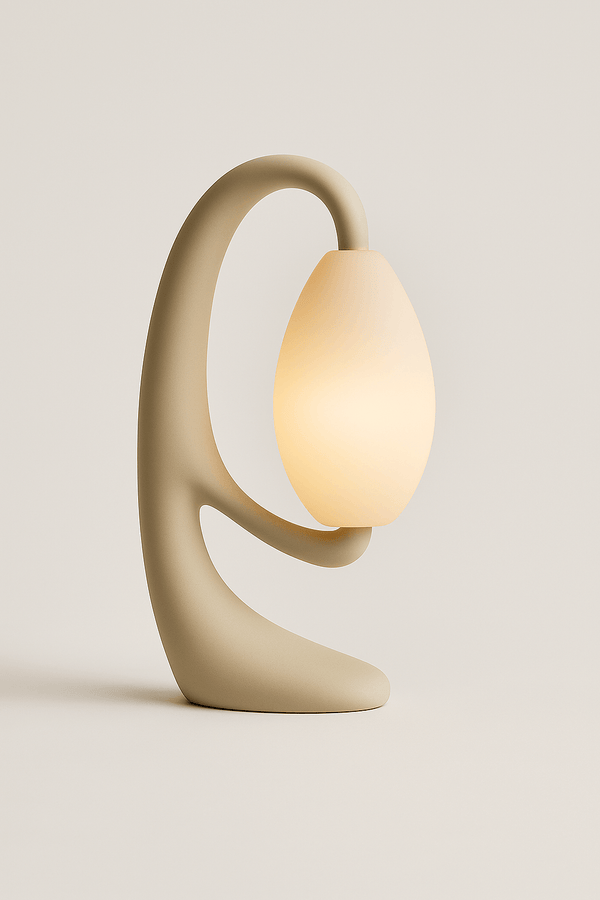 Sculptural Serenity Table Lamp with a minimalist stone-look body and frosted orb, emitting a warm ambient glow.